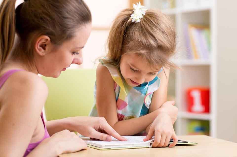 Mother teaching emotions to her autistic daughter